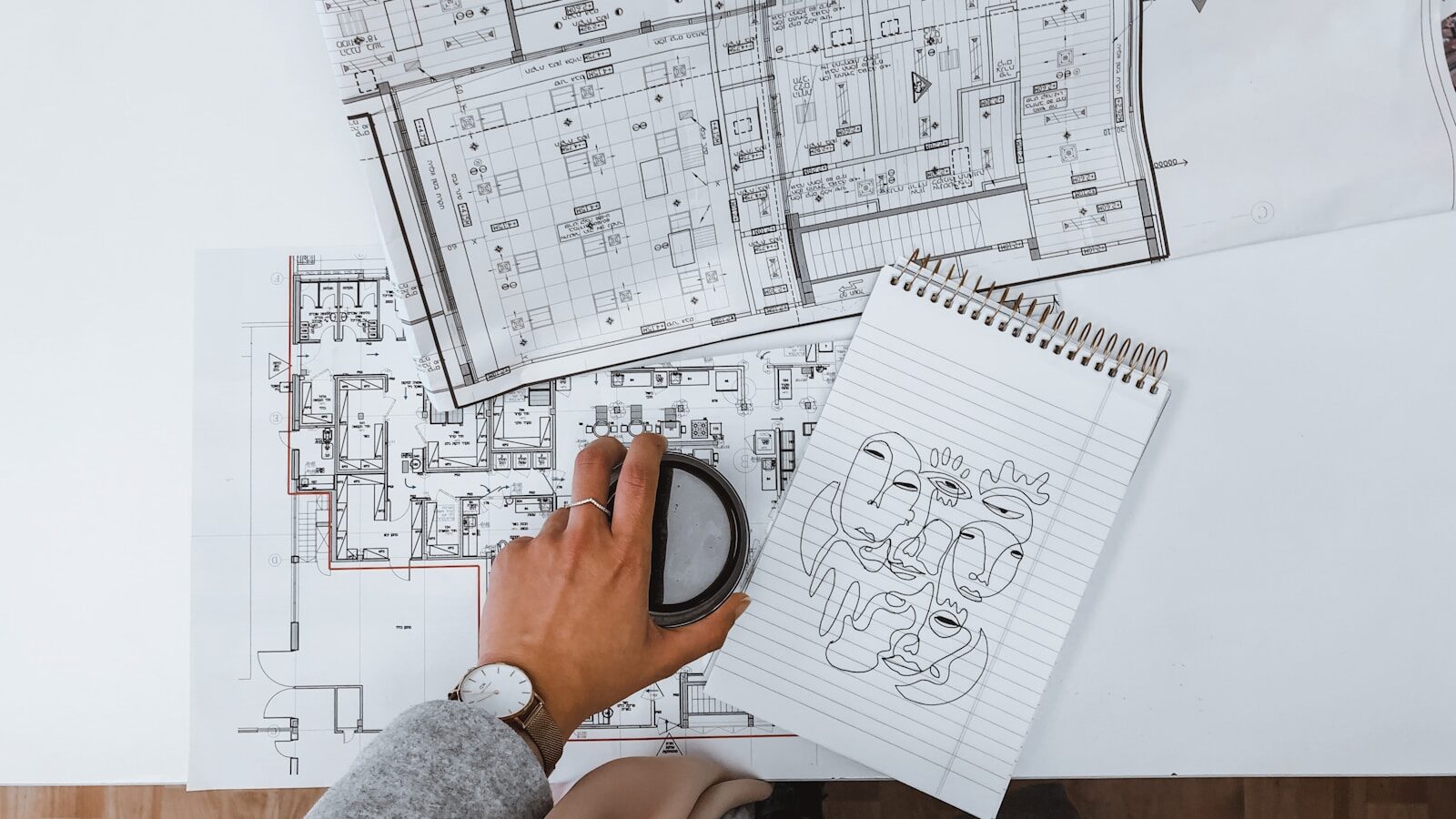 Project consultation MI Hometown Builder person holding black magnifying glass