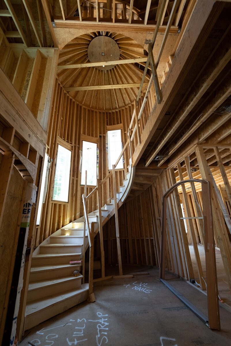 a wooden staircase in a wooden building for a custom home
